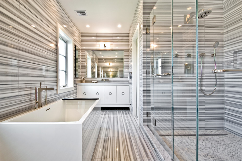 Classic grey and white bathroom in New York with a freestanding bath.