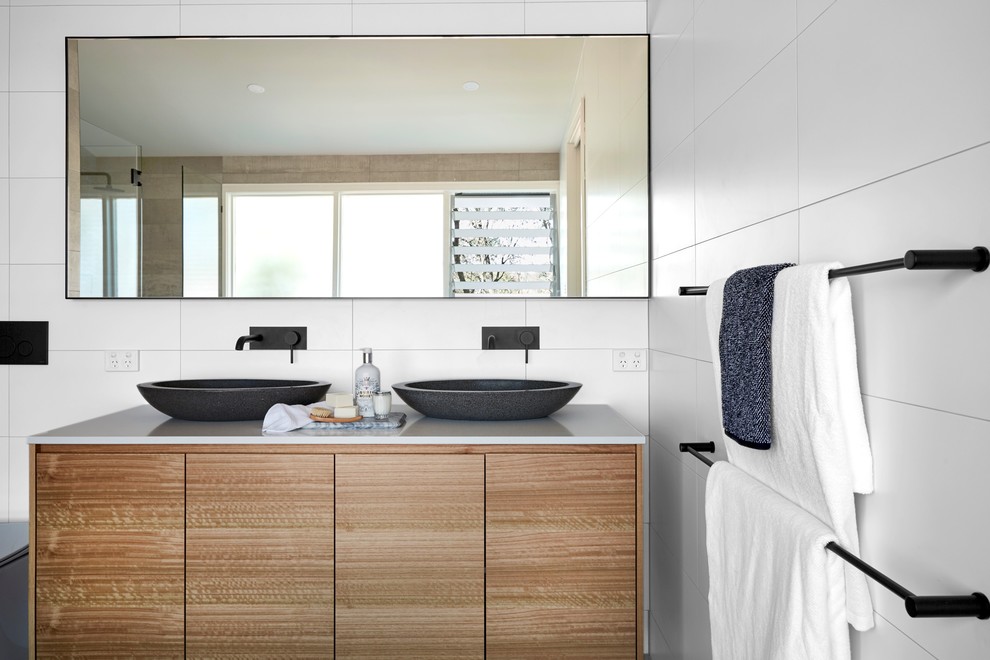 Photo of a traditional bathroom in Newcastle - Maitland with flat-panel cabinets, brown cabinets, white tiles, white walls and a vessel sink.