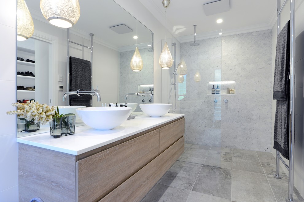 Example of a mid-sized eclectic master white tile ceramic tile and gray floor doorless shower design with flat-panel cabinets, light wood cabinets, a one-piece toilet, white walls, a vessel sink, solid surface countertops and a hinged shower door