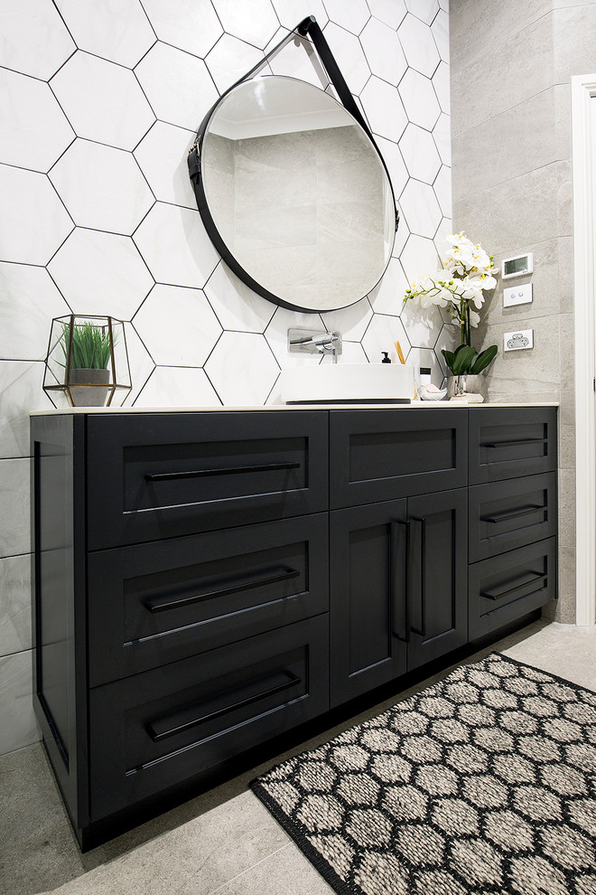 Inspiration for a mid-sized modern master gray tile and ceramic tile ceramic tile bathroom remodel in Sydney with shaker cabinets, black cabinets, gray walls, a vessel sink, quartz countertops and a hinged shower door