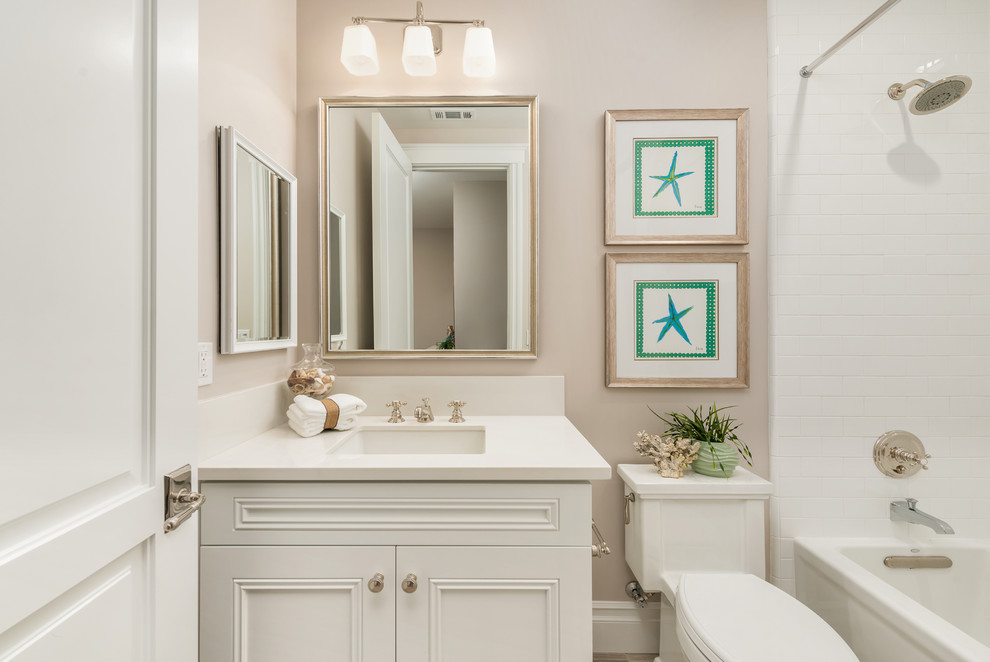 На фото: ванная комната в классическом стиле с фасадами с утопленной филенкой, белыми фасадами, накладной ванной, душем в нише, раздельным унитазом, серыми стенами, душевой кабиной, врезной раковиной и столешницей из искусственного кварца с