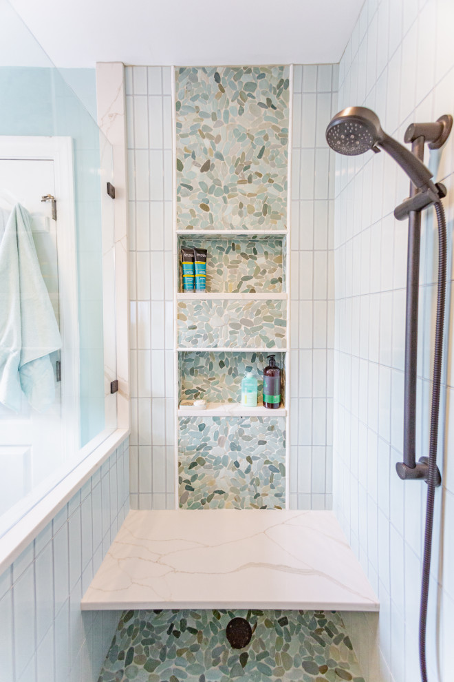 Small beach style master green tile and porcelain tile porcelain tile, beige floor and single-sink bathroom photo in Charleston with raised-panel cabinets, light wood cabinets, a two-piece toilet, green walls, an undermount sink, quartz countertops, a hinged shower door, white countertops and a built-in vanity