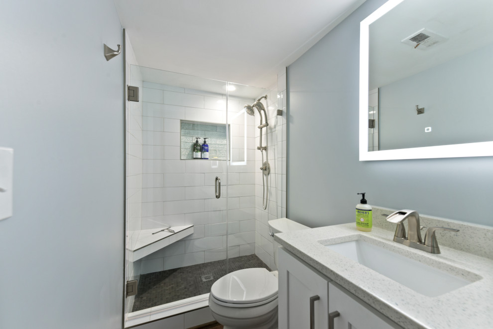 Inspiration for a small traditional bathroom in Atlanta with raised-panel cabinets, white cabinets, a one-piece toilet, white tiles, ceramic tiles, grey walls, a built-in sink, granite worktops, a hinged door and multi-coloured worktops.