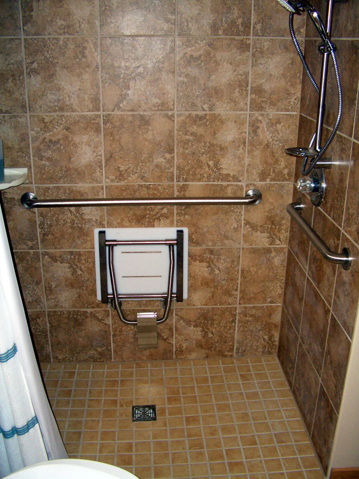 Design ideas for a classic bathroom in New York with a built-in shower, brown tiles, ceramic tiles, brown walls and ceramic flooring.
