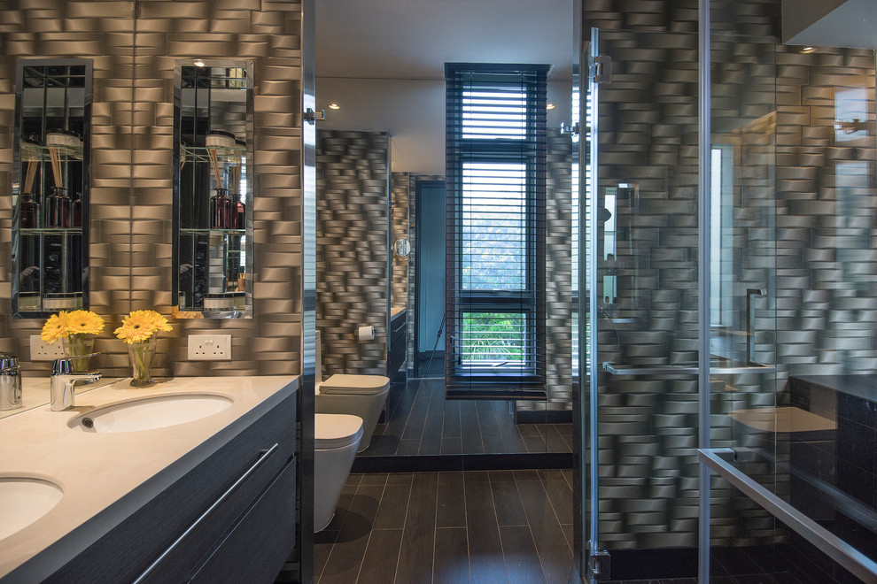 Example of a small trendy master black tile and ceramic tile ceramic tile bathroom design in Singapore with flat-panel cabinets, brown cabinets, a one-piece toilet, multicolored walls, an undermount sink and solid surface countertops