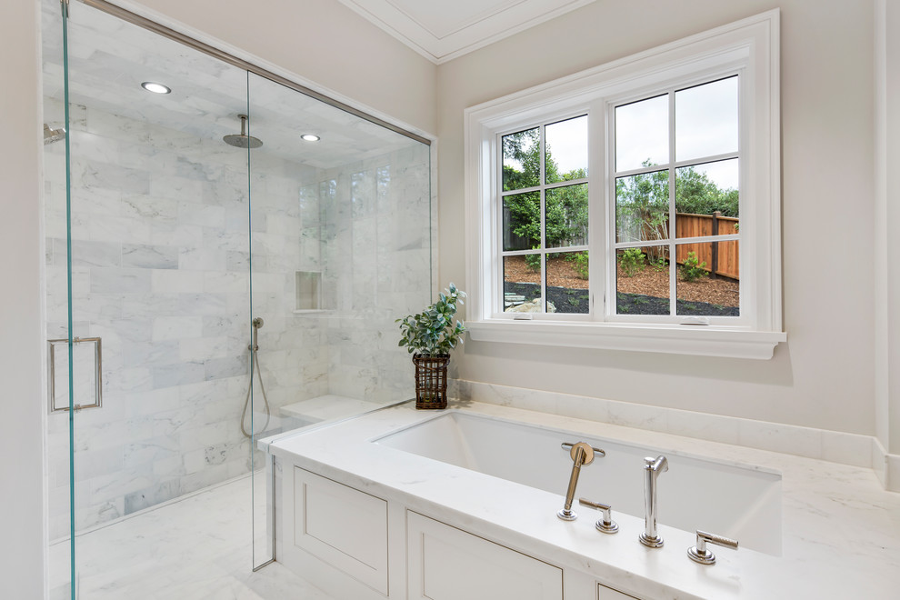 Large classic ensuite bathroom in San Francisco with shaker cabinets, white cabinets, a submerged bath, a corner shower, white tiles, marble tiles, grey walls, marble flooring, a submerged sink, marble worktops, white floors, a hinged door and white worktops.