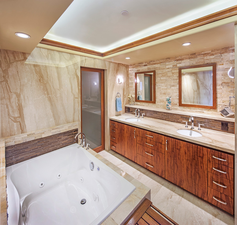 This is an example of a large contemporary ensuite bathroom in San Diego with flat-panel cabinets, dark wood cabinets, a built-in bath, brown tiles, matchstick tiles, multi-coloured walls, marble flooring, a submerged sink, marble worktops and beige floors.