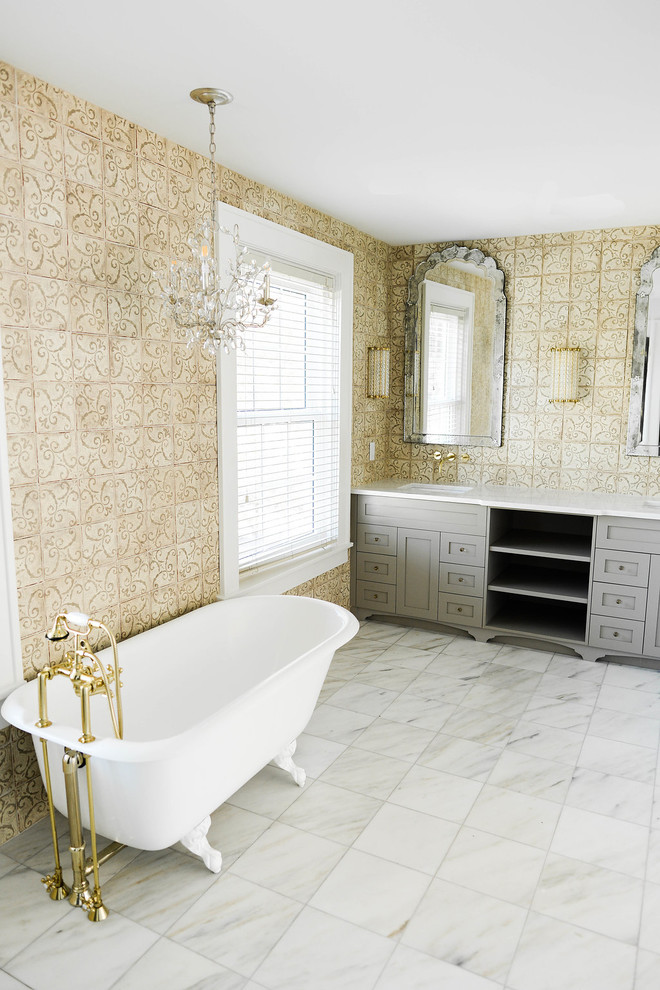 Inspiration for a large traditional ensuite bathroom in Tampa with shaker cabinets, grey cabinets, a claw-foot bath, a double shower, beige tiles, cement tiles, beige walls, marble flooring, a submerged sink, marble worktops, white floors and a hinged door.