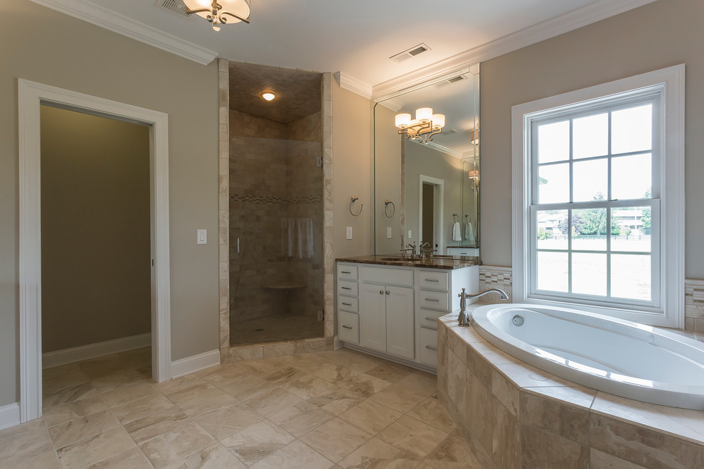 Example of a large classic master stone tile marble floor bathroom design in Louisville with marble countertops