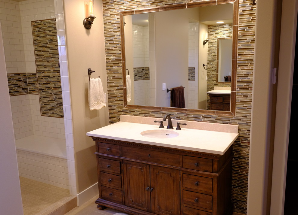Example of a mid-sized arts and crafts master beige tile and mosaic tile porcelain tile double shower design in Sacramento with a console sink, furniture-like cabinets, distressed cabinets, marble countertops and gray walls