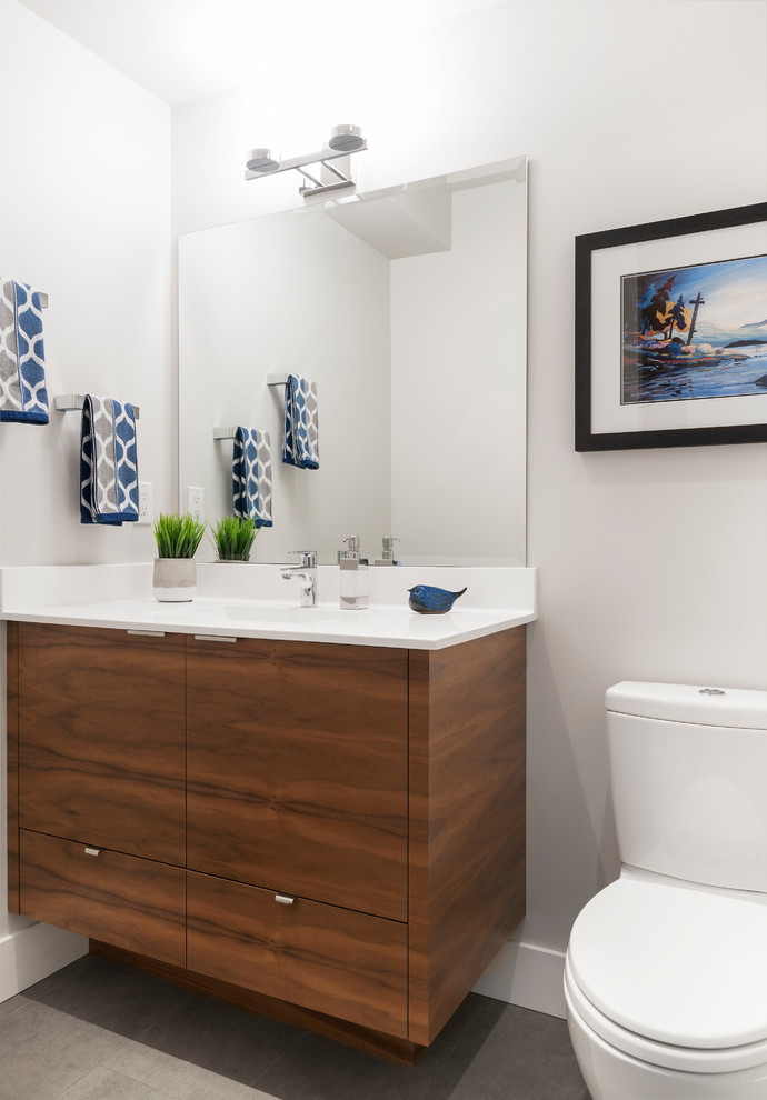 Inspiration for a medium sized traditional ensuite bathroom in Vancouver with shaker cabinets, a freestanding bath, a corner shower, a one-piece toilet, white tiles, ceramic tiles, ceramic flooring, a submerged sink, engineered stone worktops, medium wood cabinets and grey walls.