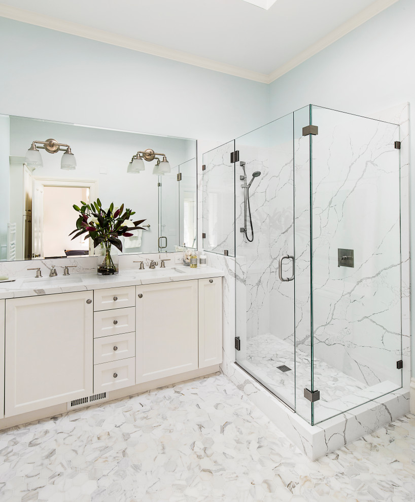 This is an example of a traditional bathroom in Other with recessed-panel cabinets, white cabinets, a corner shower, white tiles, grey walls, a submerged sink, white floors, a hinged door, white worktops, double sinks and a built in vanity unit.