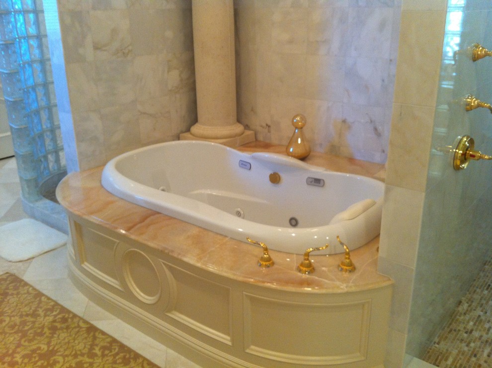 Medium sized classic ensuite bathroom in Miami with a built-in bath, a corner shower, beige tiles, stone tiles, beige walls and marble flooring.