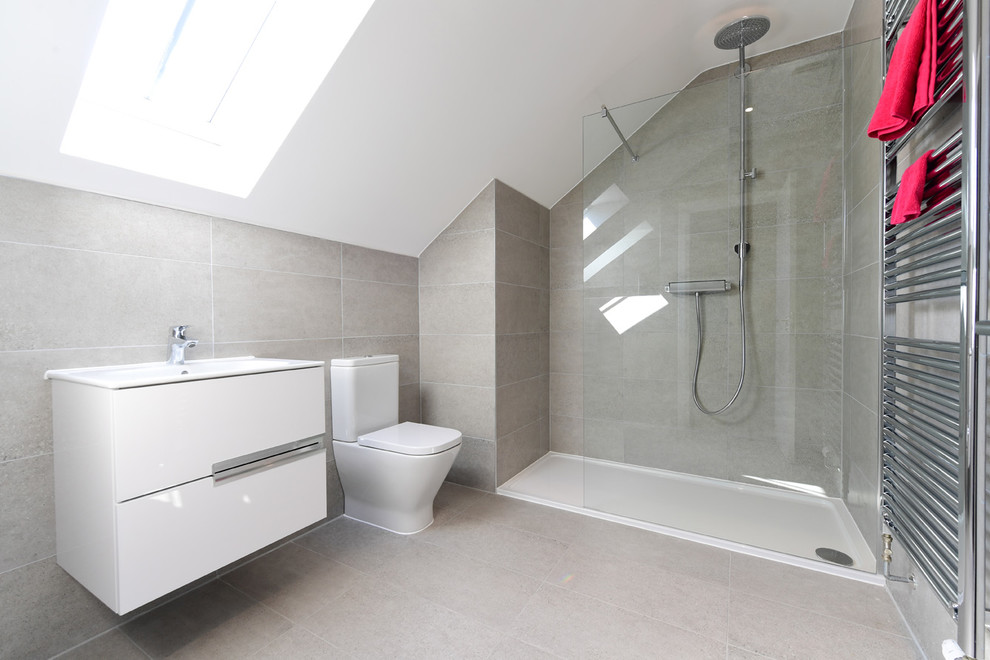 Idée de décoration pour une salle de bain design avec un carrelage gris, des carreaux de porcelaine, un mur gris, un sol en carrelage de porcelaine et un sol gris.