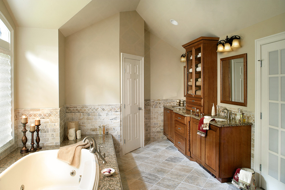This is an example of a traditional bathroom in New York with granite worktops and beige tiles.