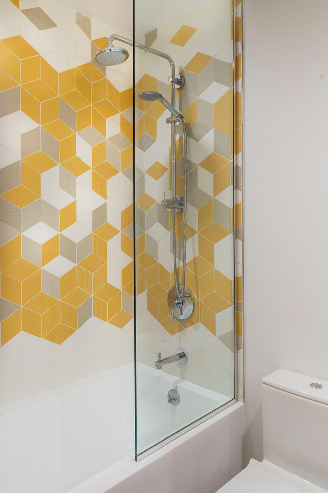 Example of a small trendy kids' multicolored tile and ceramic tile bathroom design in New York with a wall-mount toilet and white walls