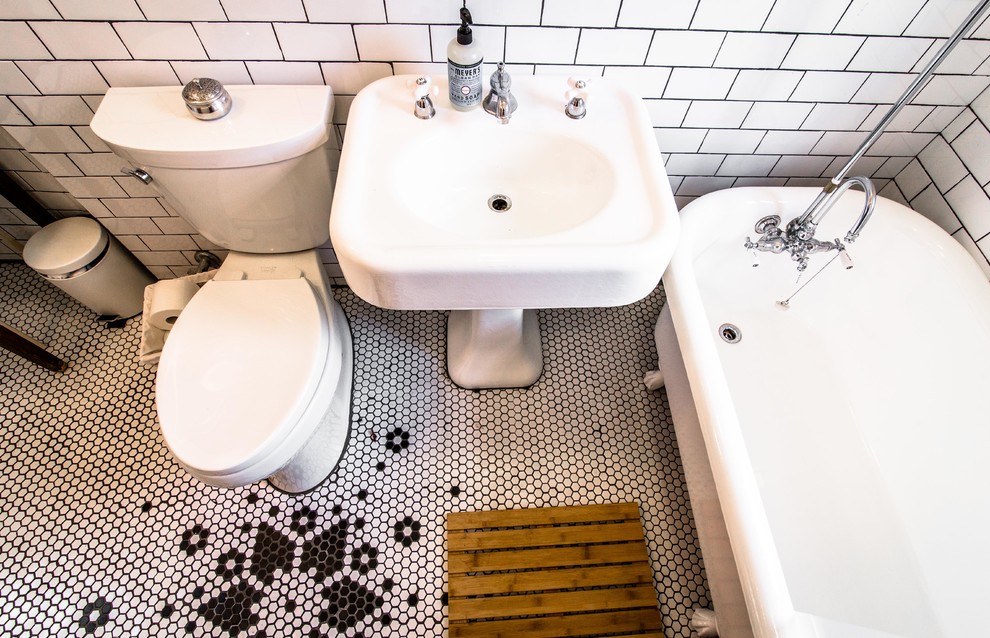 Inspiration for a small 1960s white tile and porcelain tile light wood floor bathroom remodel in New York with a pedestal sink, a two-piece toilet and beige walls