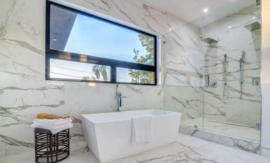 Small transitional master black and white tile and stone slab marble floor bathroom photo in Los Angeles with flat-panel cabinets, white cabinets, a one-piece toilet, white walls, an integrated sink and marble countertops