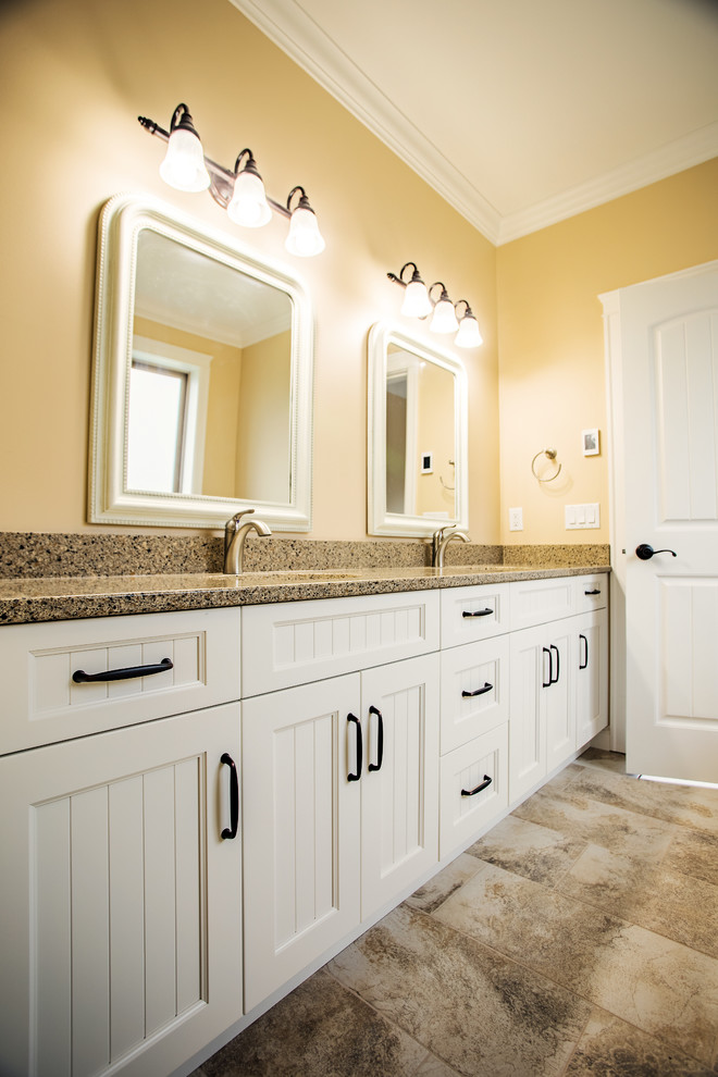 Bathroom - large traditional master beige tile and ceramic tile ceramic tile and gray floor bathroom idea in Vancouver with shaker cabinets, white cabinets, a two-piece toilet, beige walls, an undermount sink, laminate countertops, a hinged shower door and beige countertops