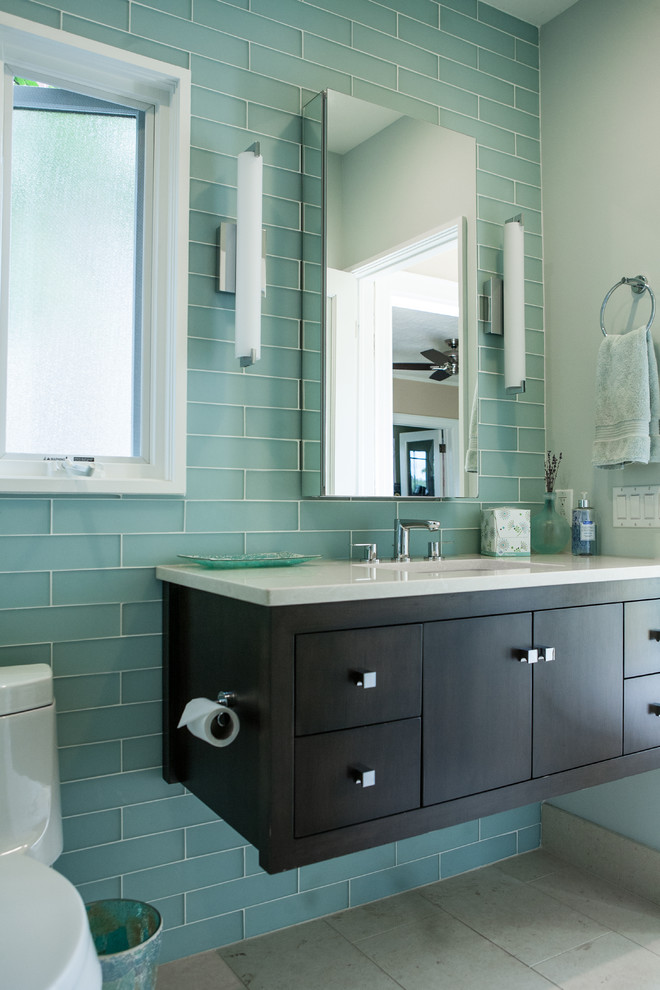 Aménagement d'une petite salle de bain éclectique en bois foncé avec un lavabo encastré, un placard à porte plane, un plan de toilette en quartz modifié, une douche d'angle, WC séparés, un carrelage vert, un carrelage en pâte de verre, un mur bleu et un sol en carrelage de porcelaine.
