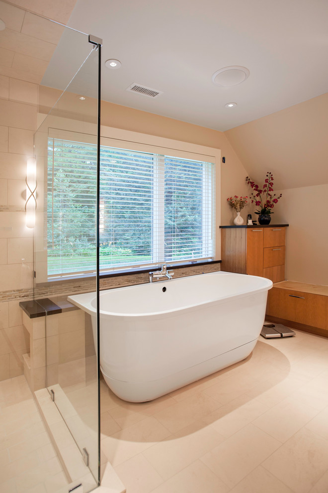 Inspiration for a medium sized contemporary ensuite bathroom in Boston with flat-panel cabinets, medium wood cabinets, a freestanding bath, a corner shower, beige tiles, porcelain tiles, beige walls, porcelain flooring, a submerged sink and solid surface worktops.