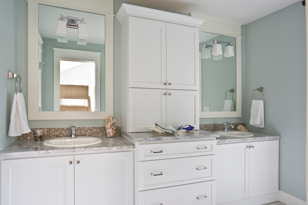 Example of a large classic kids' bathroom design in Grand Rapids with recessed-panel cabinets, white cabinets, blue walls, a drop-in sink and granite countertops