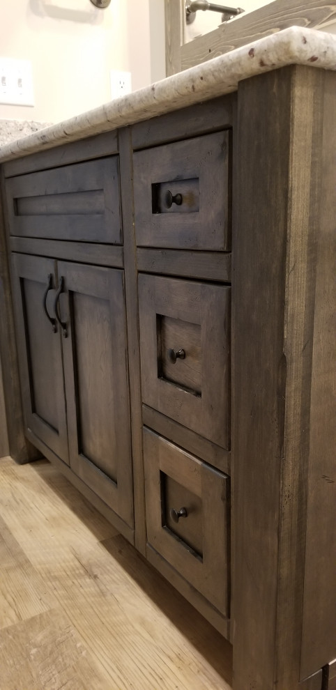 Bathroom - rustic 3/4 vinyl floor, brown floor and single-sink bathroom idea in Grand Rapids with flat-panel cabinets, dark wood cabinets, a two-piece toilet, an undermount sink, solid surface countertops, gray countertops and a built-in vanity