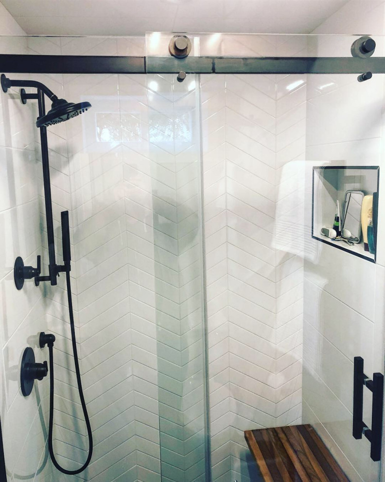 Photo of a small contemporary shower room bathroom in New York with flat-panel cabinets, dark wood cabinets, an alcove shower, a one-piece toilet, white tiles, ceramic tiles, white walls, porcelain flooring, a vessel sink, engineered stone worktops, black floors, a sliding door, white worktops, a shower bench, a single sink and a freestanding vanity unit.