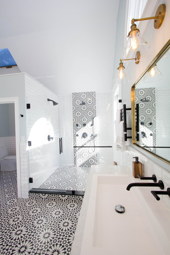 This is an example of a large mediterranean ensuite wet room bathroom in Boston with shaker cabinets, white cabinets, a freestanding bath, a two-piece toilet, black and white tiles, metro tiles, blue walls, cement flooring, a vessel sink, marble worktops, black floors, a hinged door and white worktops.