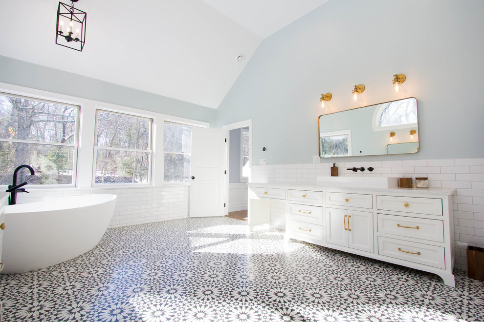 Large tuscan master black and white tile and subway tile cement tile floor and black floor bathroom photo in Boston with shaker cabinets, white cabinets, a two-piece toilet, blue walls, a vessel sink, marble countertops, a hinged shower door and white countertops