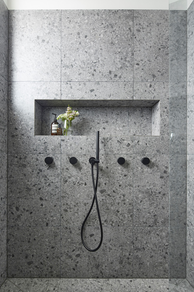 Inspiration for a medium sized contemporary ensuite bathroom in Melbourne with white cabinets, a double shower, a wall mounted toilet, grey tiles, stone slabs, grey walls, terrazzo flooring, a wall-mounted sink, laminate worktops, grey floors, a hinged door, white worktops and freestanding cabinets.