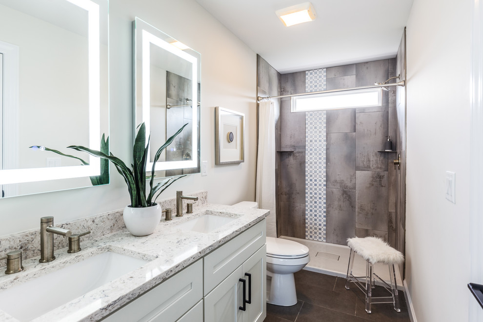 Idée de décoration pour une douche en alcôve tradition avec un placard à porte shaker, des portes de placard blanches, un carrelage gris, un mur blanc, un lavabo encastré, un sol gris, une cabine de douche avec un rideau, un plan de toilette blanc et meuble double vasque.