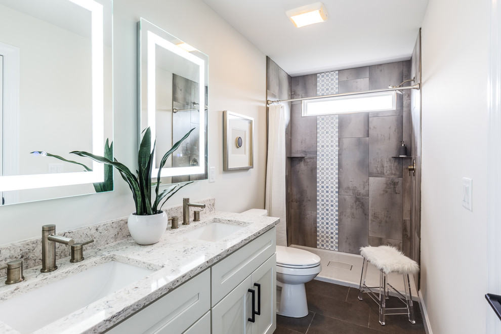 Transitional gray tile gray floor and double-sink bathroom photo in Cincinnati with shaker cabinets, white cabinets, white walls, an undermount sink and white countertops