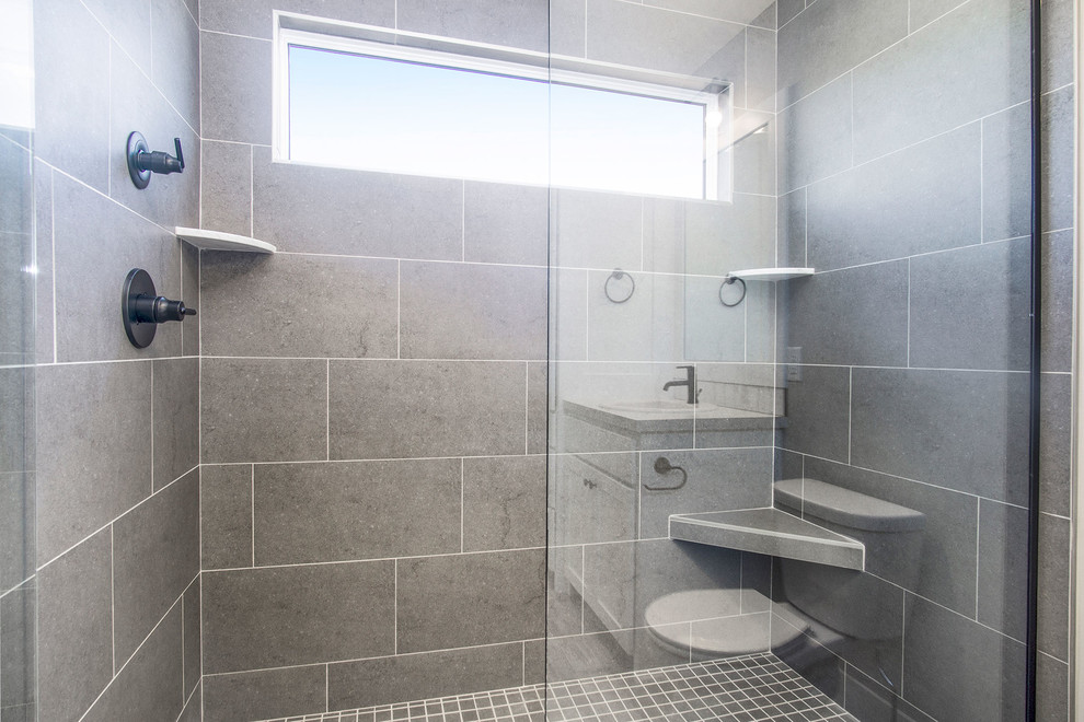 Inspiration for a medium sized contemporary ensuite bathroom in Grand Rapids with shaker cabinets, white cabinets, a built-in bath, an alcove shower, a two-piece toilet, grey tiles, slate tiles, grey walls, porcelain flooring, a built-in sink, beige floors, a hinged door and beige worktops.