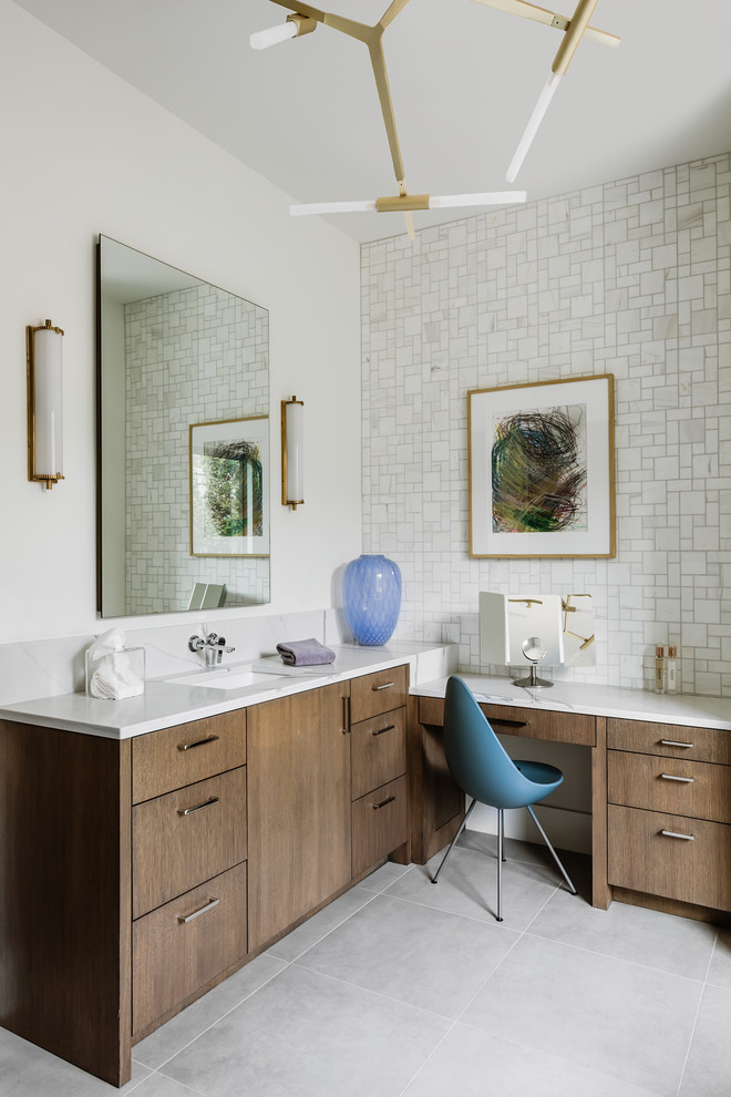 Contemporary bathroom in Oklahoma City with flat-panel cabinets, medium wood cabinets, white walls, a submerged sink, grey floors and white worktops.