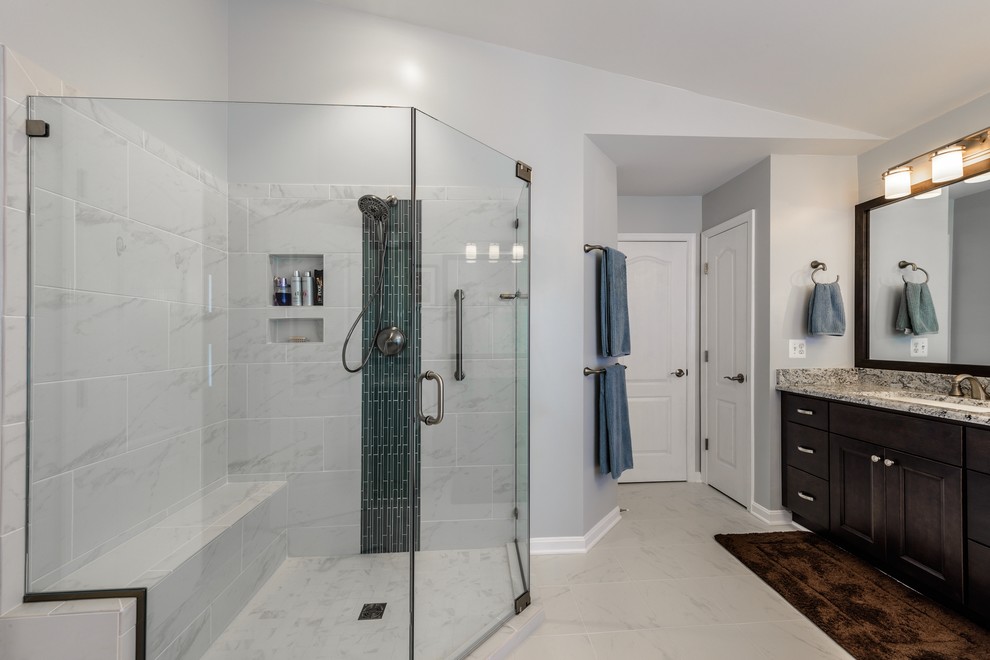 Design ideas for a large classic ensuite bathroom in DC Metro with a submerged sink, recessed-panel cabinets, dark wood cabinets, granite worktops, a corner bath, a corner shower, a two-piece toilet, white tiles, ceramic tiles, grey walls and ceramic flooring.