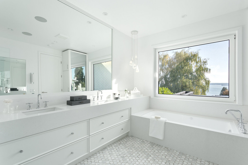 Photo of a nautical ensuite bathroom in Vancouver with white cabinets, a built-in bath, white walls and white worktops.
