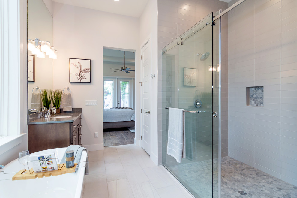 Bathroom - large modern master gray tile and ceramic tile porcelain tile and gray floor bathroom idea in Orlando with shaker cabinets, dark wood cabinets, a one-piece toilet, gray walls, an undermount sink, quartz countertops and gray countertops