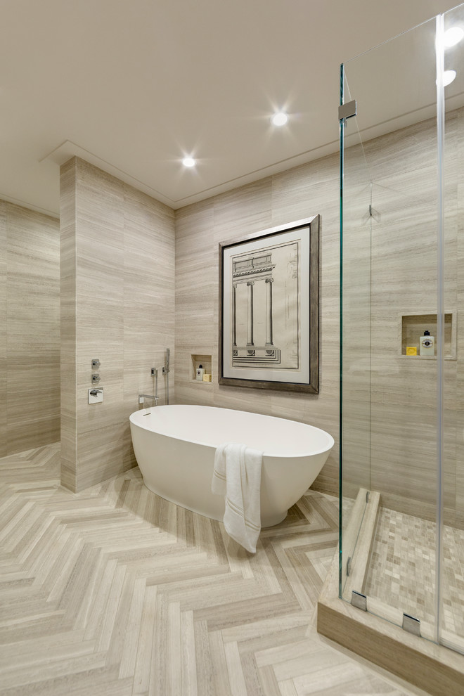 This is an example of a small modern ensuite bathroom in New York with a freestanding bath, beige tiles, limestone tiles, beige walls, limestone flooring, limestone worktops and beige floors.