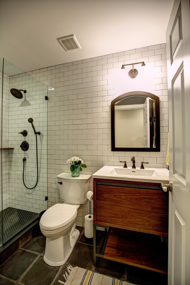 Exemple d'une douche en alcôve éclectique en bois brun avec un placard à porte plane, WC séparés, un carrelage noir et blanc, des carreaux de porcelaine, un mur gris, un sol en carrelage de porcelaine, un lavabo intégré et un plan de toilette en surface solide.