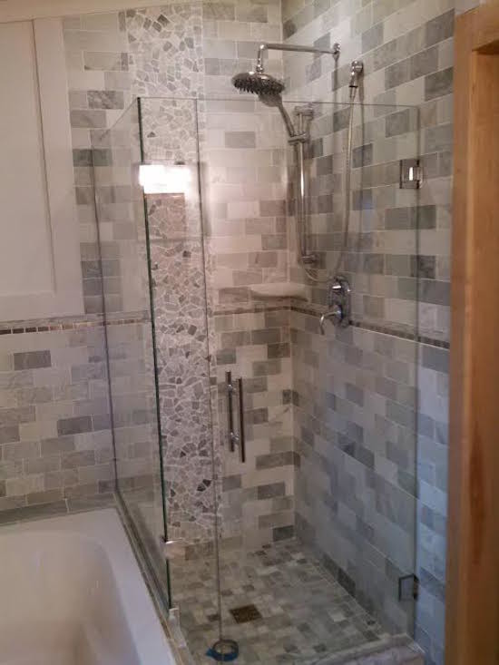 Design ideas for a medium sized modern bathroom in Minneapolis with a corner shower, grey tiles, white tiles and a hinged door.