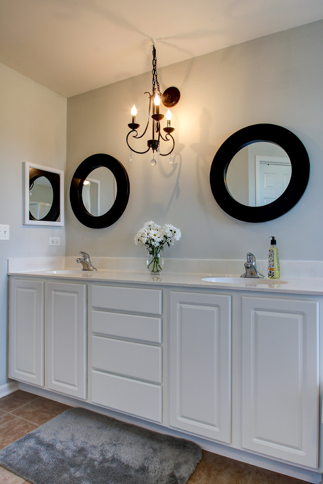 This is an example of a classic bathroom in Chicago with raised-panel cabinets and white cabinets.