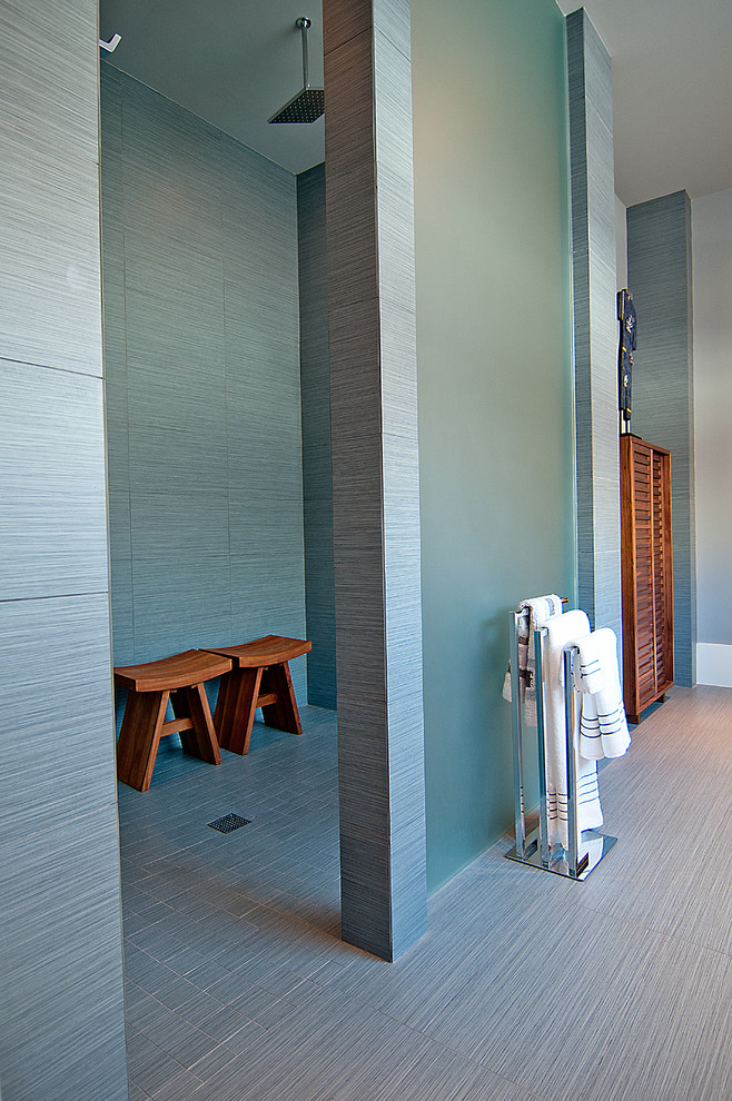 This is an example of a contemporary bathroom in Houston with a walk-in shower and grey tiles.