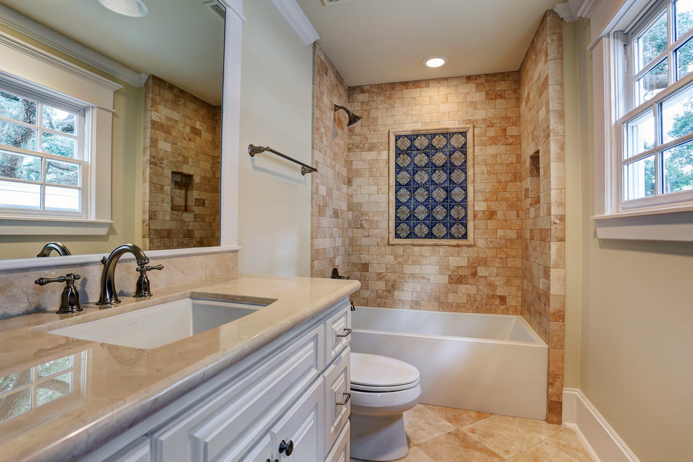 Bathroom - mid-sized craftsman beige tile and stone tile travertine floor bathroom idea in Houston with an undermount sink, raised-panel cabinets, white cabinets, granite countertops, a two-piece toilet and beige walls