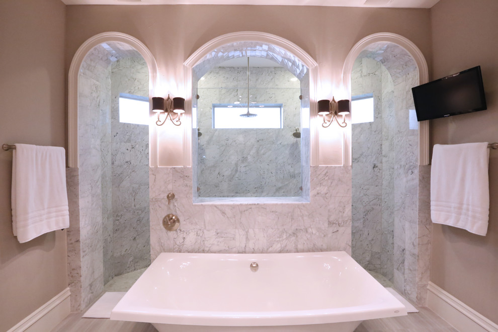 Example of a large trendy master travertine floor bathroom design in Houston with a vessel sink, recessed-panel cabinets, white cabinets and marble countertops