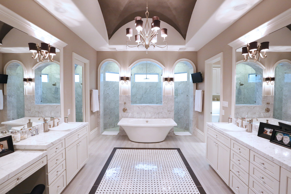 Large trendy master travertine floor bathroom photo in Houston with a vessel sink, recessed-panel cabinets, white cabinets and marble countertops