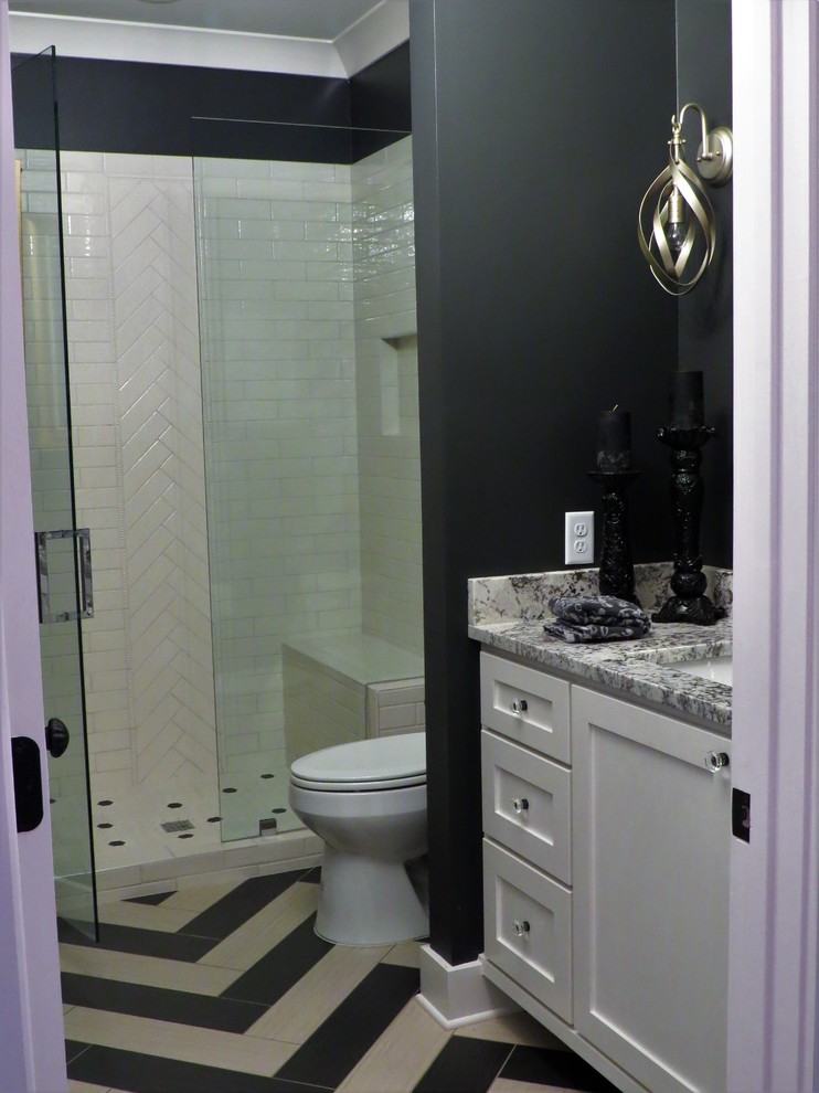 Inspiration for a small eclectic black and white tile and ceramic tile porcelain tile and multicolored floor alcove shower remodel in Little Rock with shaker cabinets, white cabinets, black walls, an undermount sink, granite countertops, a hinged shower door and multicolored countertops