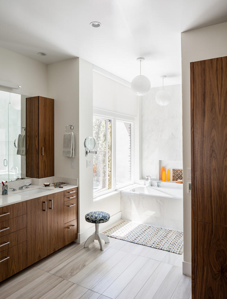 На фото: ванная комната среднего размера в стиле модернизм с плоскими фасадами, фасадами цвета дерева среднего тона, накладной ванной, душем без бортиков, белой плиткой, керамической плиткой, белыми стенами и полом из керамической плитки с