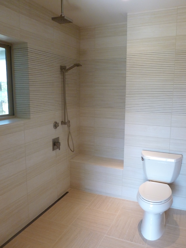 Inspiration for a small contemporary master beige tile and ceramic tile ceramic tile doorless shower remodel in Orlando with an undermount sink, flat-panel cabinets, light wood cabinets, granite countertops, a two-piece toilet and beige walls