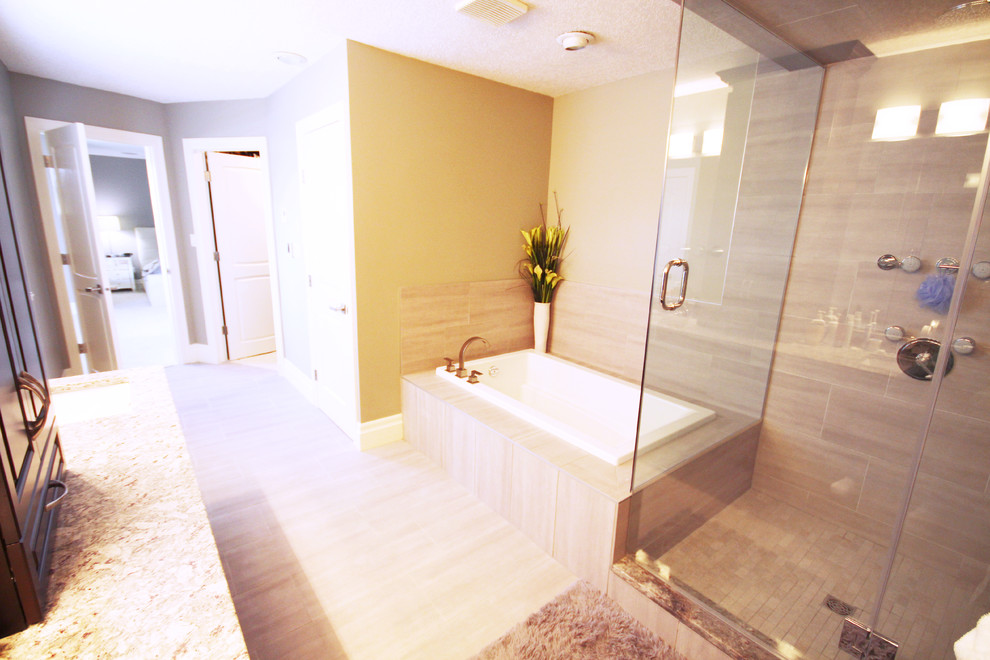 Exemple d'une douche en alcôve principale chic en bois foncé avec un lavabo encastré, un placard avec porte à panneau surélevé, un plan de toilette en granite, une baignoire posée, un carrelage gris, des carreaux de céramique, un mur gris et un sol en carrelage de céramique.